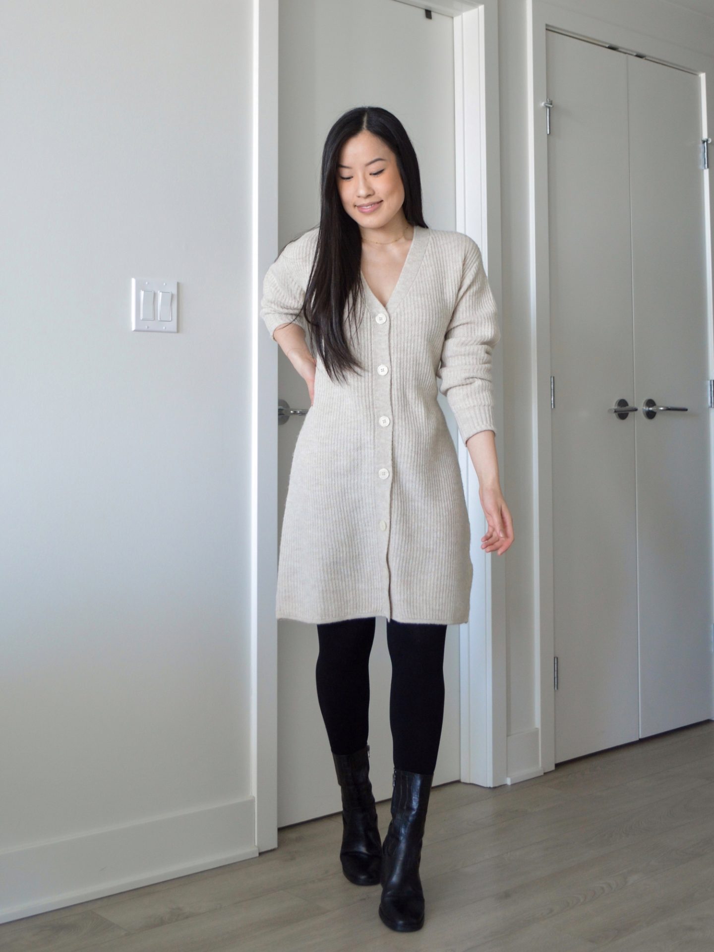 Sharon of Her Simple Sole is wearing the Frank and Oak The Recycled Wool Cardigan Dress with tights and black ankle boots.