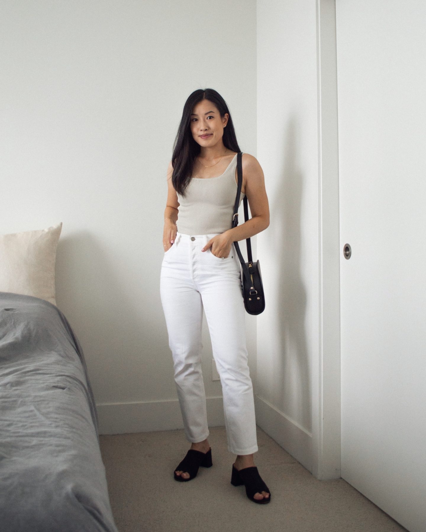 Summer Outfit Details: Babaton Sculpt Knit Tank, Denim Forum Arlo Straight Jeans in white, A.P.C. Black Demi-Lune Bag, Poppy Barley Black Mules