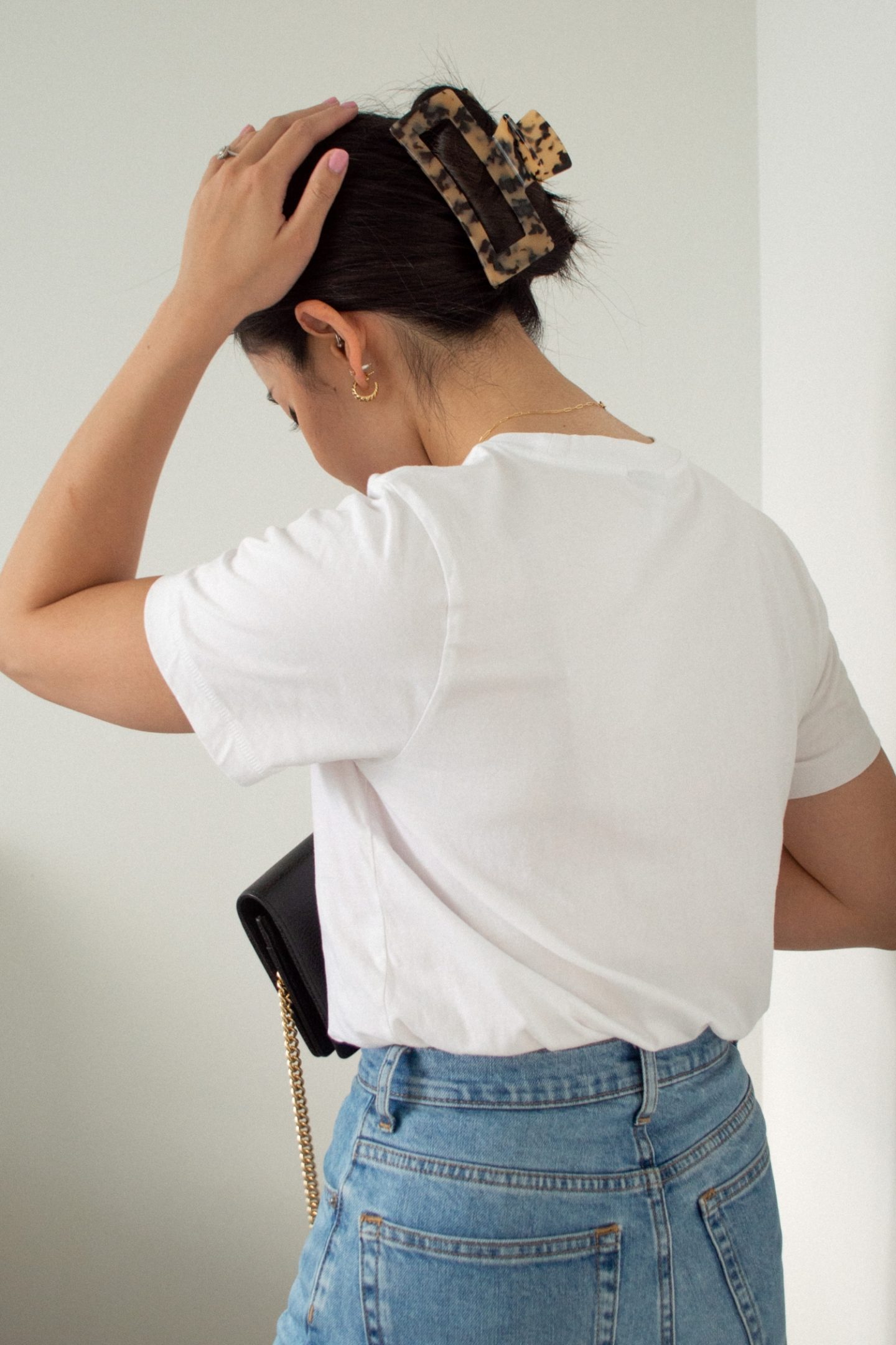 Outfit Details: Frank and Oak The Good Cotton Essential T-Shirt, Everlane Original Cheeky Jean, Gucci Marmont Leather Mini Chain Bag, Kov Essentials claw hair clip, Mejuri Croissant Dome Hoops