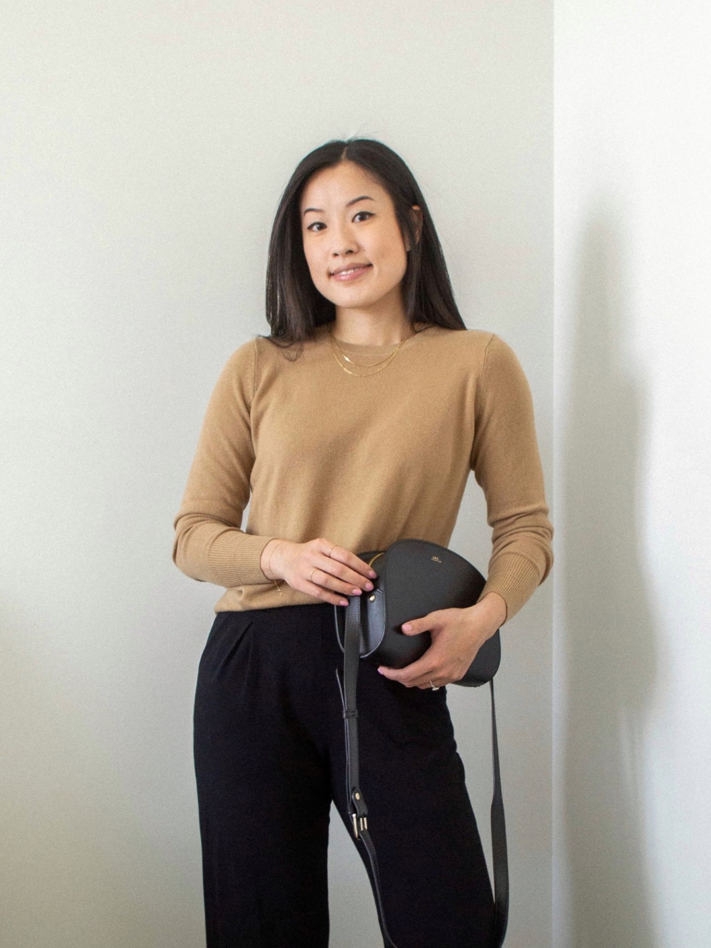 Outfit details: cashmere crewneck sweater, black wide leg pants, black crossbody bag, gold chain layered necklaces