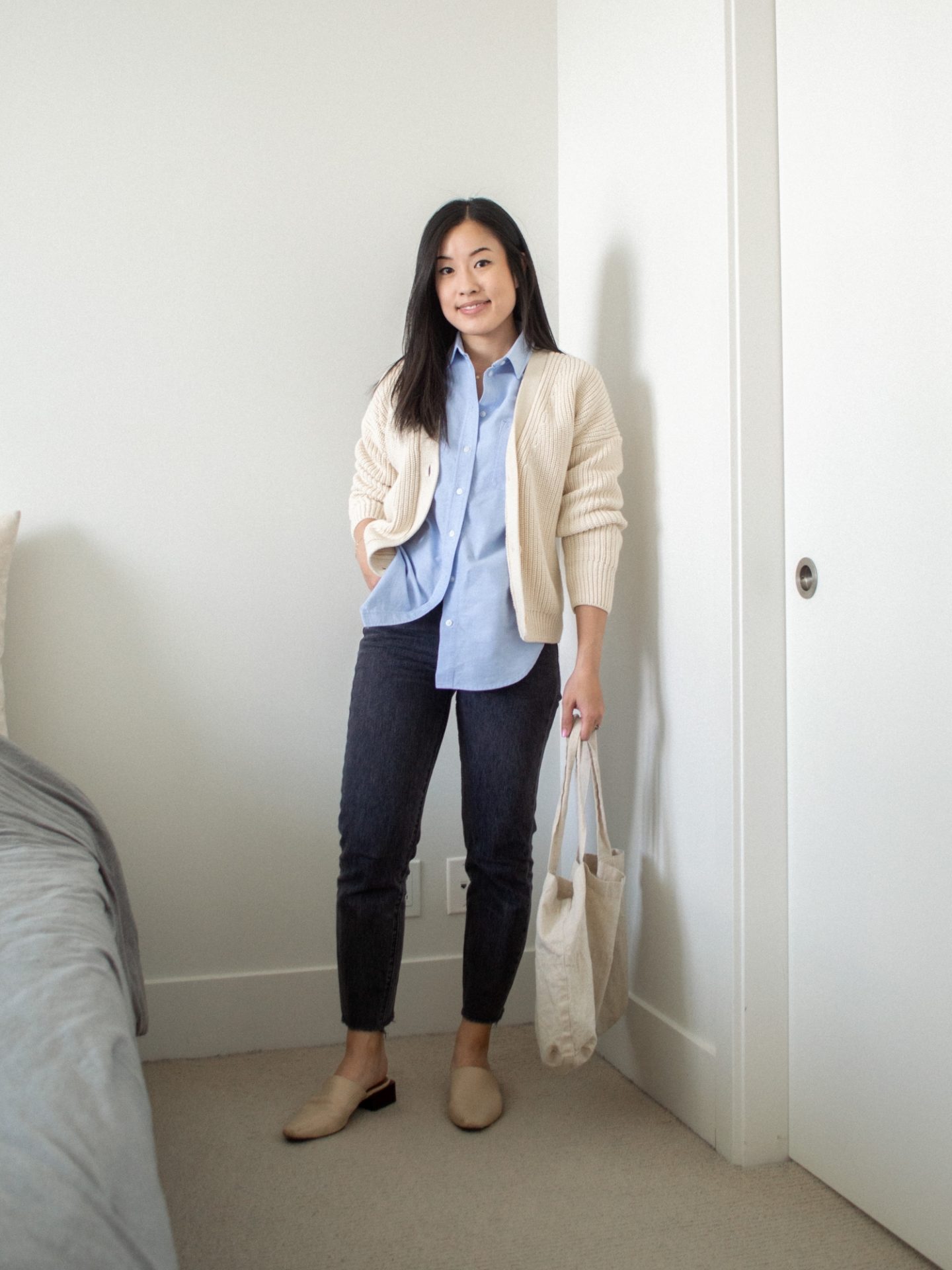 Outfit details: Tradlands Shelter Cardigan in Birch, Everlane Relaxed Oxford Shirt, Levi's Wedgie Straight Jeans, Maguire Boutique Navio Mules, Harly Jae Zero Waste Tote, fall transition outfit, layering outfit for fall, cozy cardigan outfit