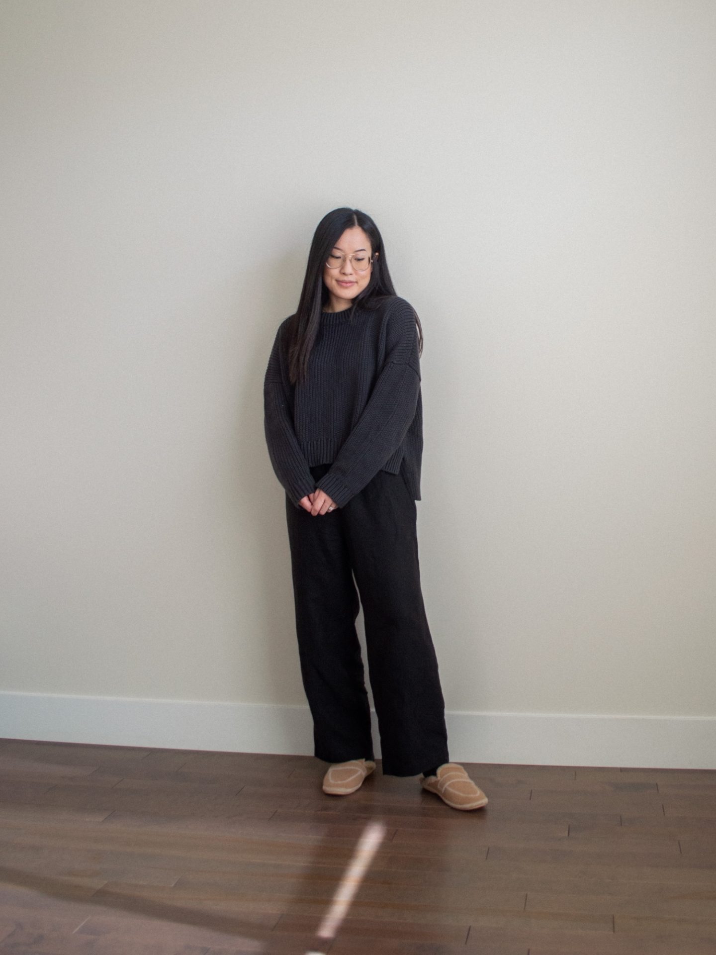 Outfit details: Tradlands Cottage Crewneck Sweater and Paloma Linen Pant, brown house slippers. Her Simple Sole blog, work from home outfit, minimalist black monochrome outfit, oversized cotton sweater, easy casual outfit