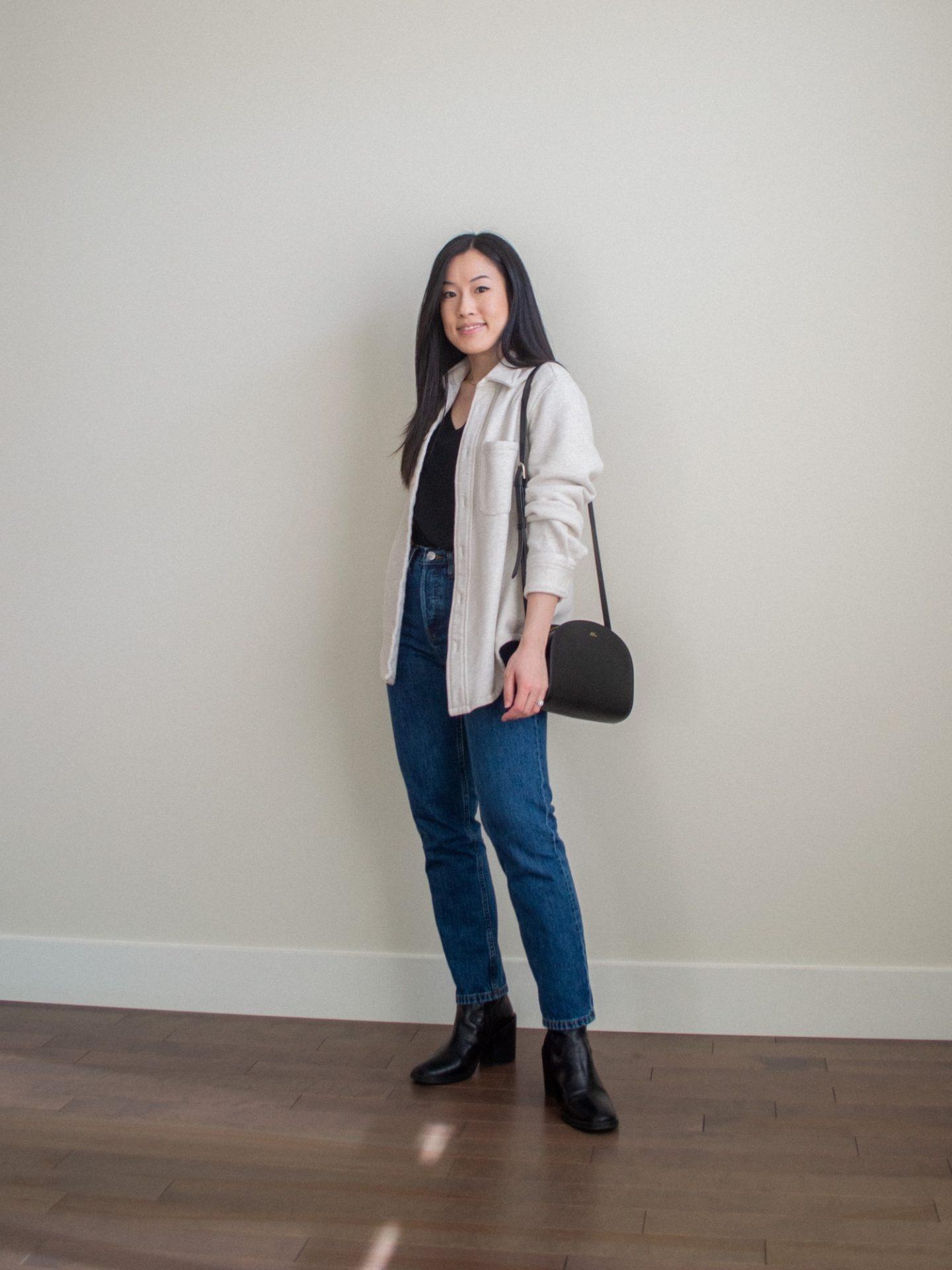 Outfit details: cream shirt jacket, black v-neck t-shirt, dark blue denim jeans, black mid-calf boots, black half moon bag, black coat outfit. Her Simple Sole blog, casual winter outfit