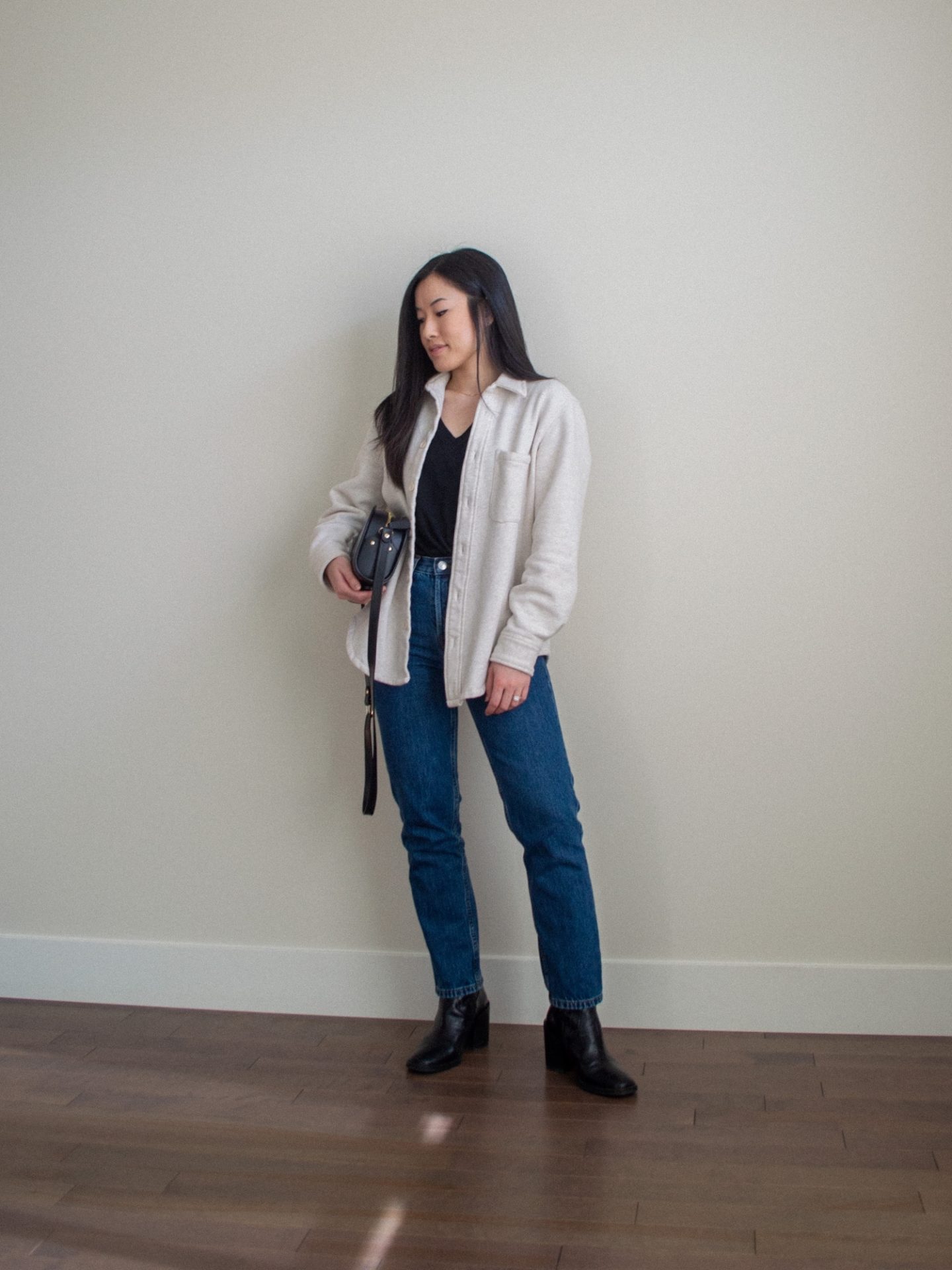 Her Simple Sole - A Recap: Shop Your Winter Wardrobe Style Challenge. Outfit details: cream shirt jacket, black v-neck t-shirt, dark blue denim jeans, black mid-calf boots, black half moon bag, black coat outfit, Her Simple Sole blog, casual winter outfit