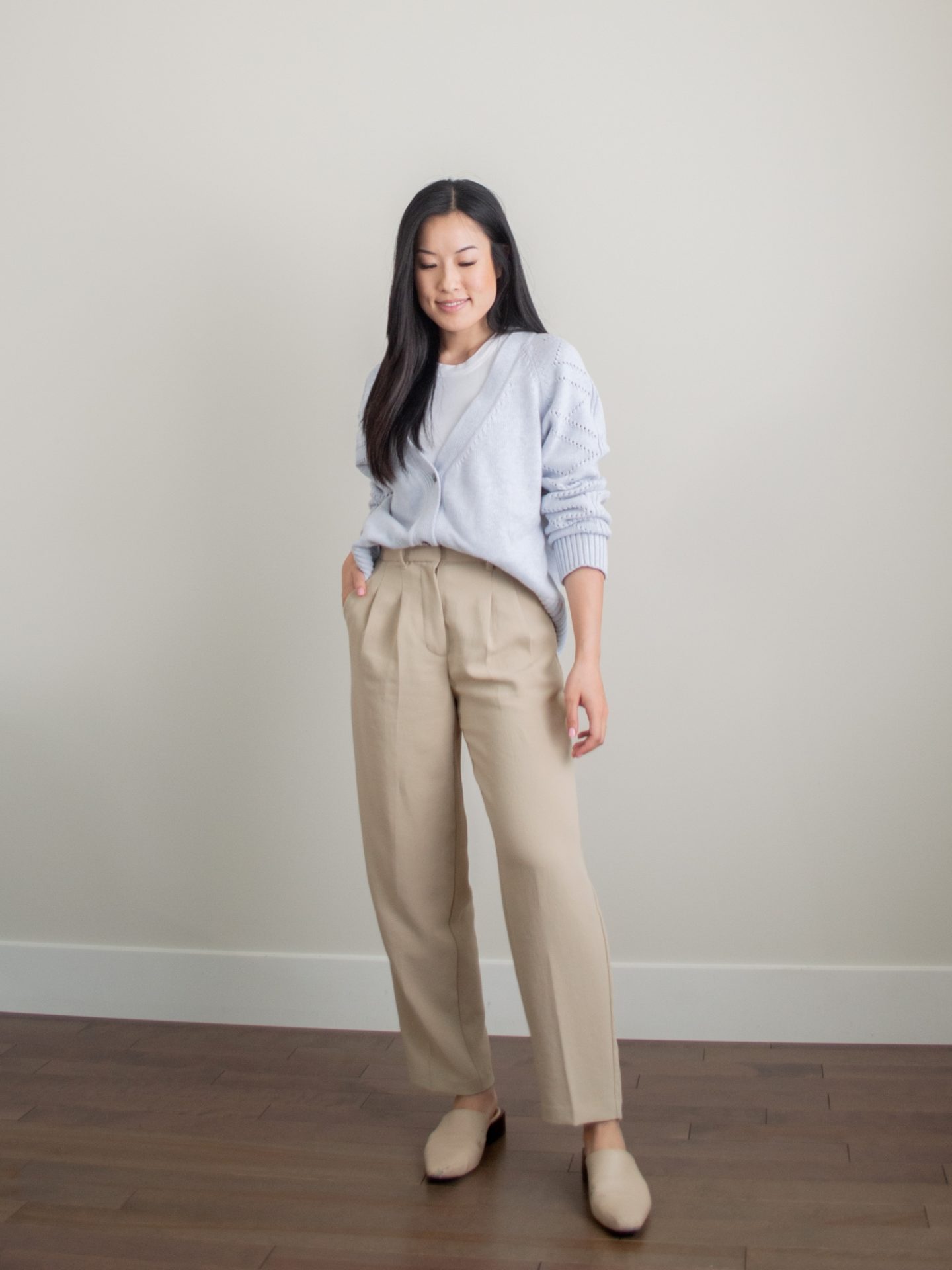 Outfit details - blue cotton and wool blend cardigan, basic white tank top, tan trousers, trousers style, beige mules, quality wardrobe essentials, closet staples