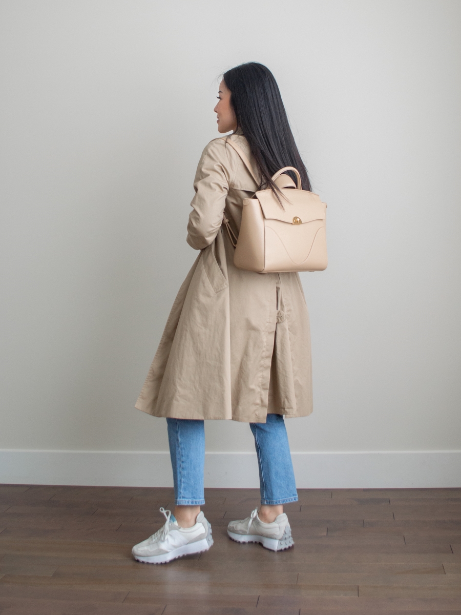 Blue straight leg jeans, classic trench coat outfit, New Balance 327 outfit, workwear backpack, perfect personal handbag, Oleada Wavia bag in Champagne
