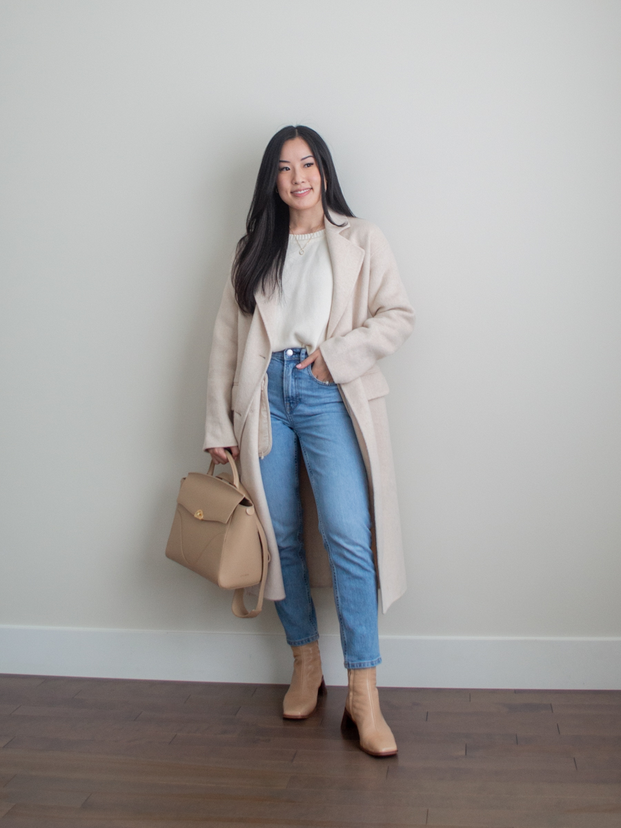 Her Simple Sole outfit photo featuring Oak + Fort cream wool coat, Everlane The Original Cheeky Jeans, Able Clothing Lily Pullover Sweater, Lintervalle ankle boots, Oleada Wavia bag in Champagne