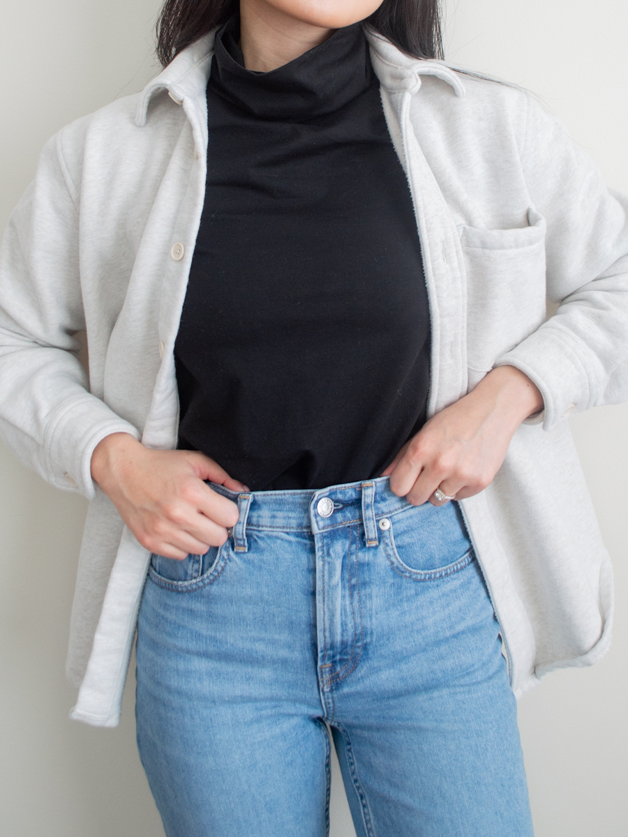 Close up outfit photo featuring the Tradlands Monty Turtleneck top with blue straight leg jeans and a fleece shirt jacket