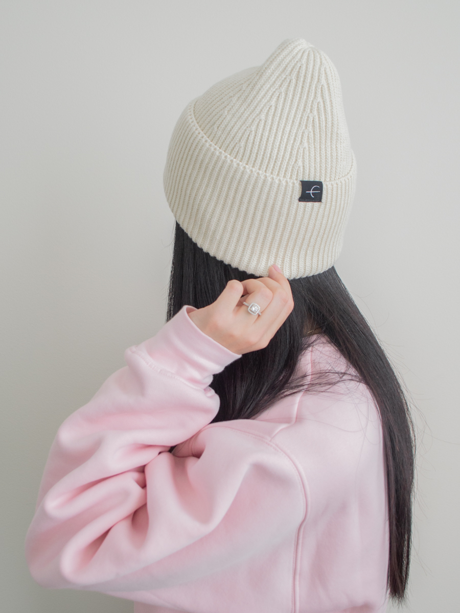 Close up photo from behind of the Paper Label Dani Toque and an oversized pink sweatshirt