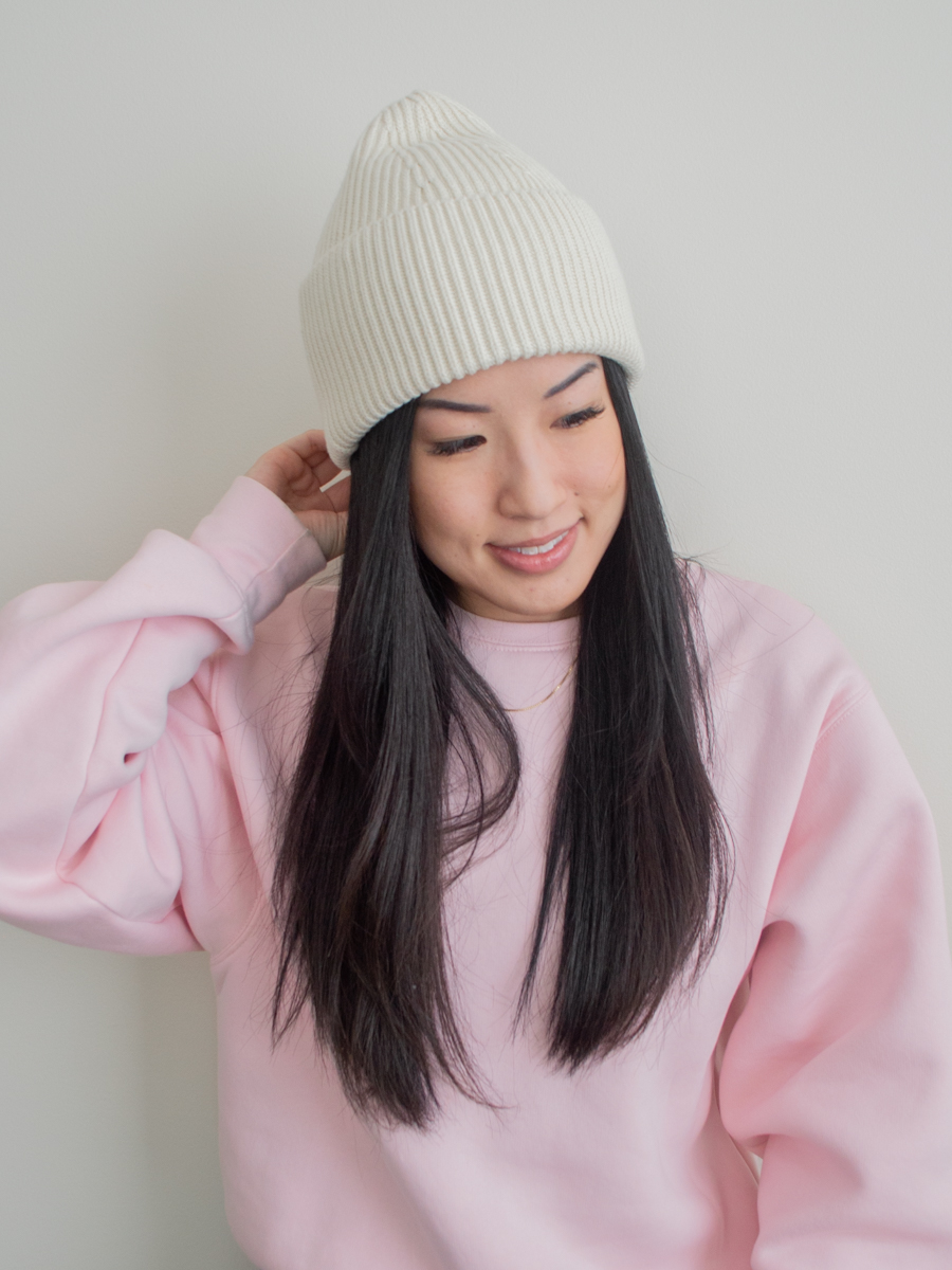 Close up photo of the Paper Label Dani Toque and an oversized pink sweatshirt, intentional gifts under $100, best winter accessories, chunky cotton beanie