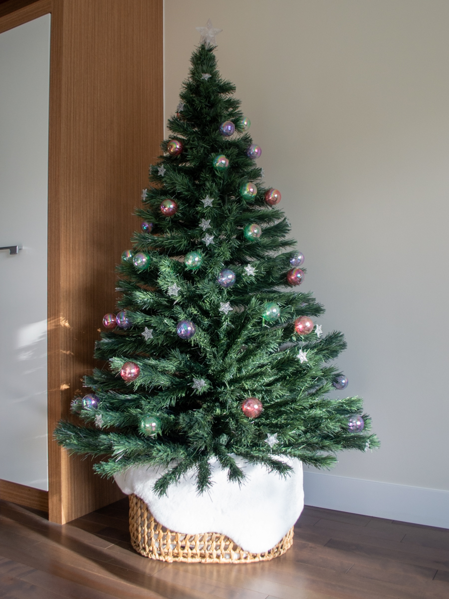 Her Simple Sole intentional home ideas with prelit optic fibre Christmas tree with basket and faux fur rug