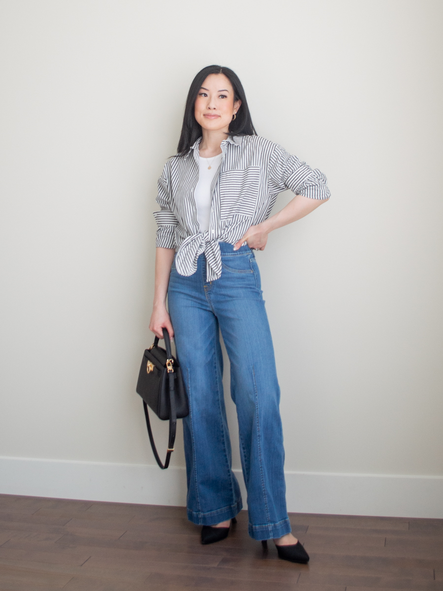 Intentional Life & Style Content Creator Sharon of Her Simple Sole is wearing a minimal outfit featuring a black and white striped button up shirt, a white rib tank top, blue wide leg jeans, pointed toe sling back heels, and a classic black top handle bag | simple styling tips | smart casual outfit | the three color rule | the third piece rule | fashion style tips