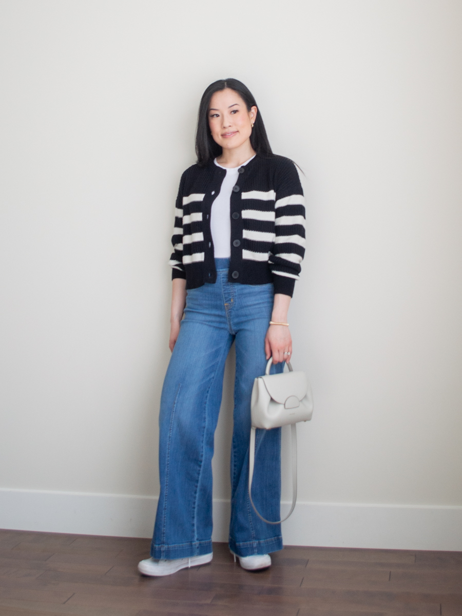 Intentional Life & Style Content Creator Sharon of Her Simple Sole is wearing a smart casual spring outfit featuring a black and white striped cardigan, a white rib tank top, blue wide leg jeans, monochrome white Converse sneakers, and a Polene crossbody bag | simple styling tips | smart casual outfit | the three color rule | the third piece rule | fashion style tips | cardigan outfit