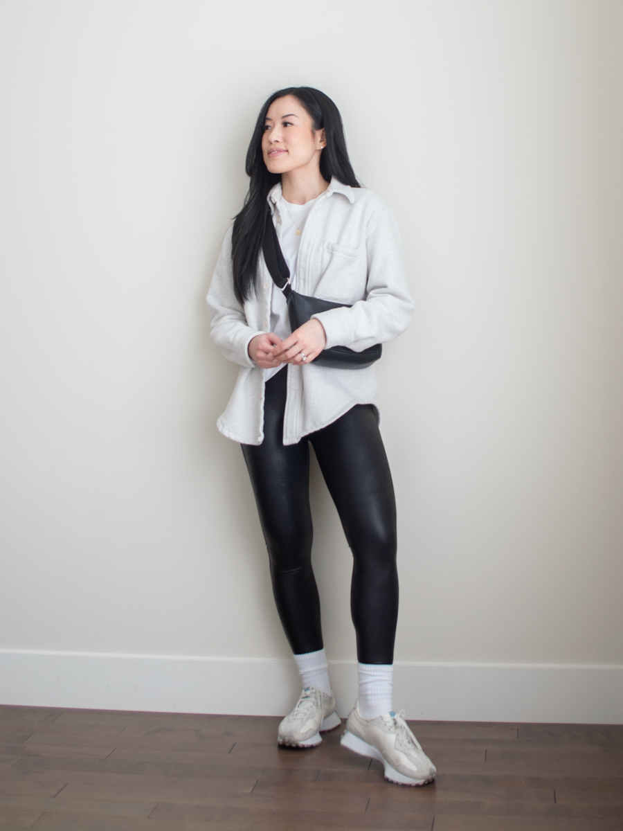 Athletisure outfit featuring a white shirt jack, basic white t-shirt, black leggings, new balance 327 sneakers. slouchy crossbody bag | casual spring outfit