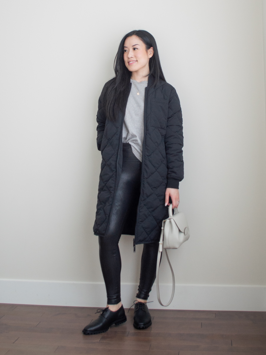 Smart casual outfit featuring a loose fitting t-shirt, black leggings, Oxford shoes, white crossbody bag, and a quilted long jacket | spring outfit idea