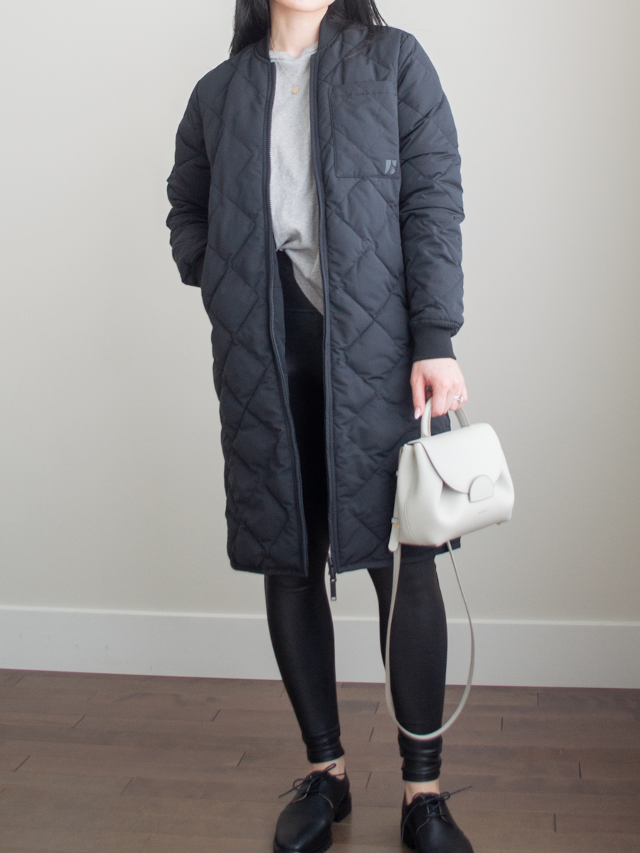 Smart casual outfit featuring a loose fitting t-shirt, black leggings, Oxford shoes, white crossbody bag, and a quilted long jacket | spring outfit idea