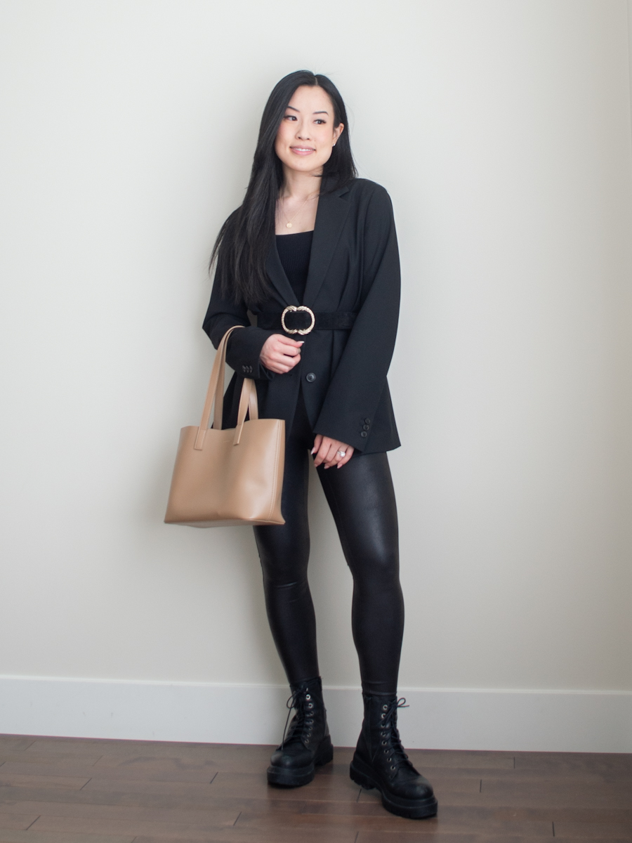 Outfit details: Uniqlo relaxed blazer, Aritzia sculpt knit tank top, Spanx faux leather leggings, Sezane Artemis belt, L'intervalle boots, Samara Rhian mini tote | Monochrome black outfit, spring outfit idea, smart casual outfit, black edgy outfit