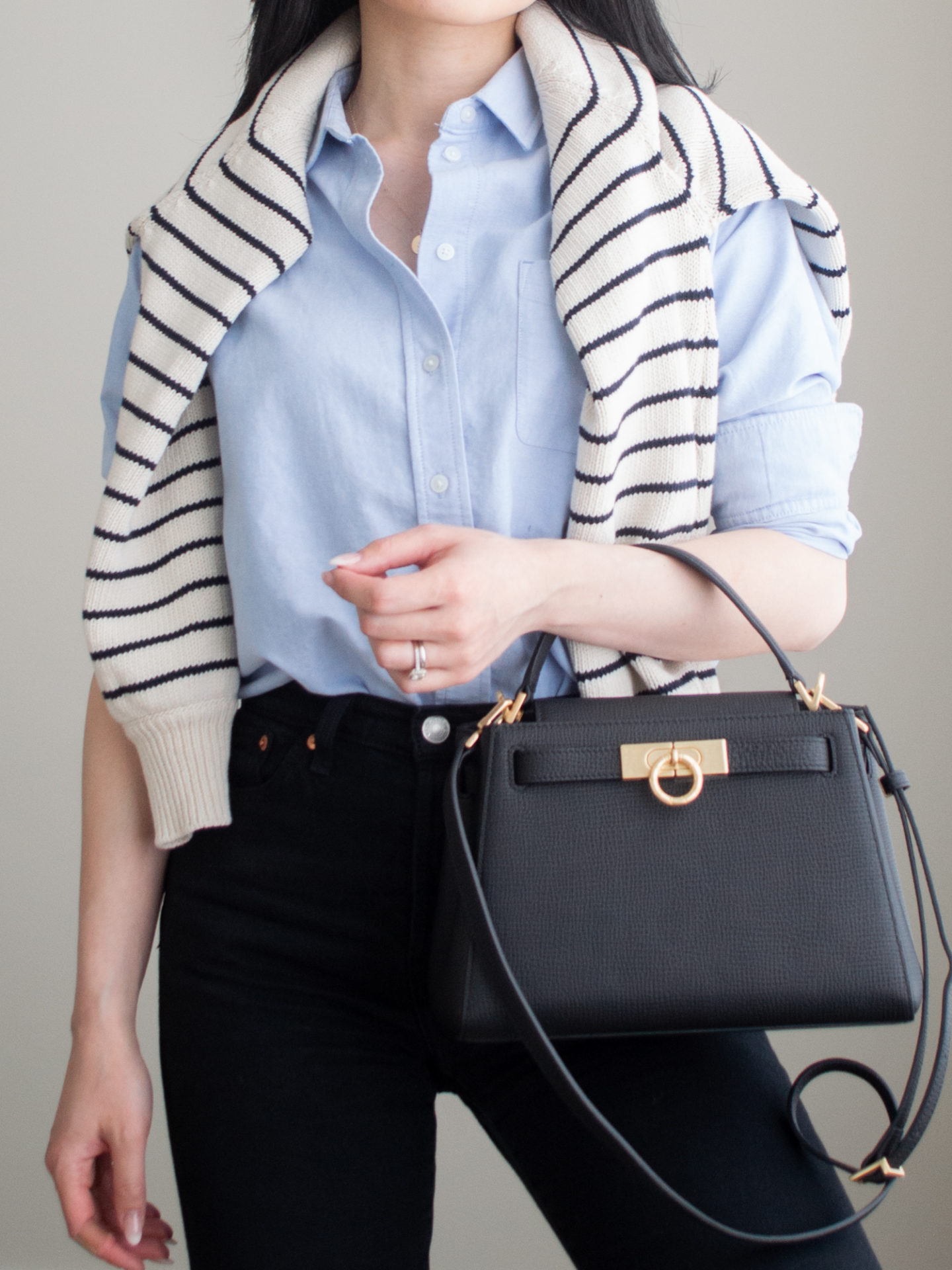 Close-up detailed outfit shot of Sharon of Her Simple Sole wearing minimal, comfortable, and functional items from her intentional wardrobe | minimalist outfit ideas | blue relaxed oxford shirt outfit | smart casual outfit | sweater over the shoulders outfit