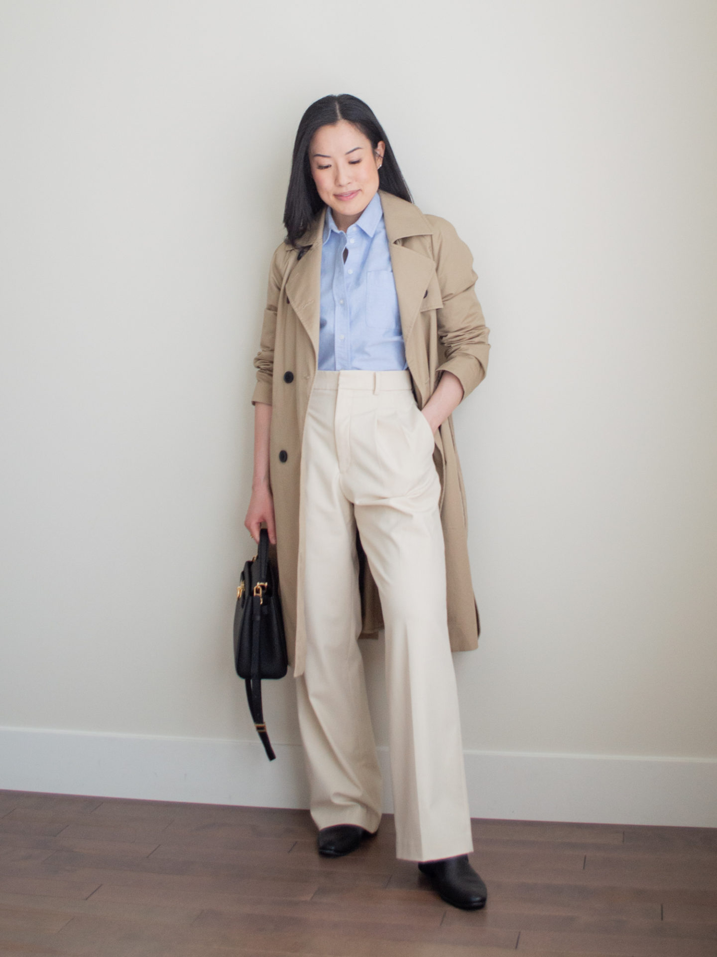 Sharon of Her Simple Sole showcases some of her favourite easy spring outfits that anyone can recreate using minimal, comfortable, and functional items from her intentional wardrobe | spring outfit ideas | minimalist outfit ideas | button up shirt and trench coat outfit | blue relaxed oxford button up shirt outfit | cream trousers outfit | business casual outfit