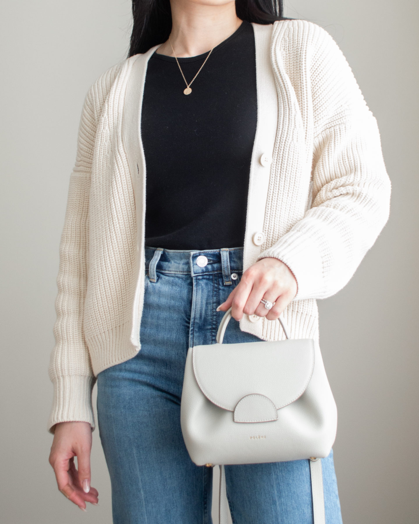 Close-up detailed outfit shot of Sharon of Her Simple Sole wearing minimal, comfortable, and functional items from her intentional wardrobe | minimalist outfit ideas | cotton cardigan and jeans outfit