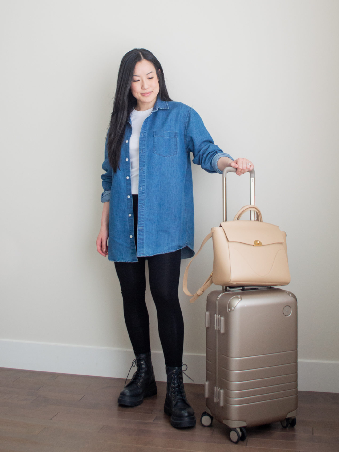 Sharon of Her Simple Sole showcases what to pack for vacation, including minimal and functional outfit ideas | oversized denim shirt outfit | denim shirt and leggings outfit | airport outfit idea | vacation packing list