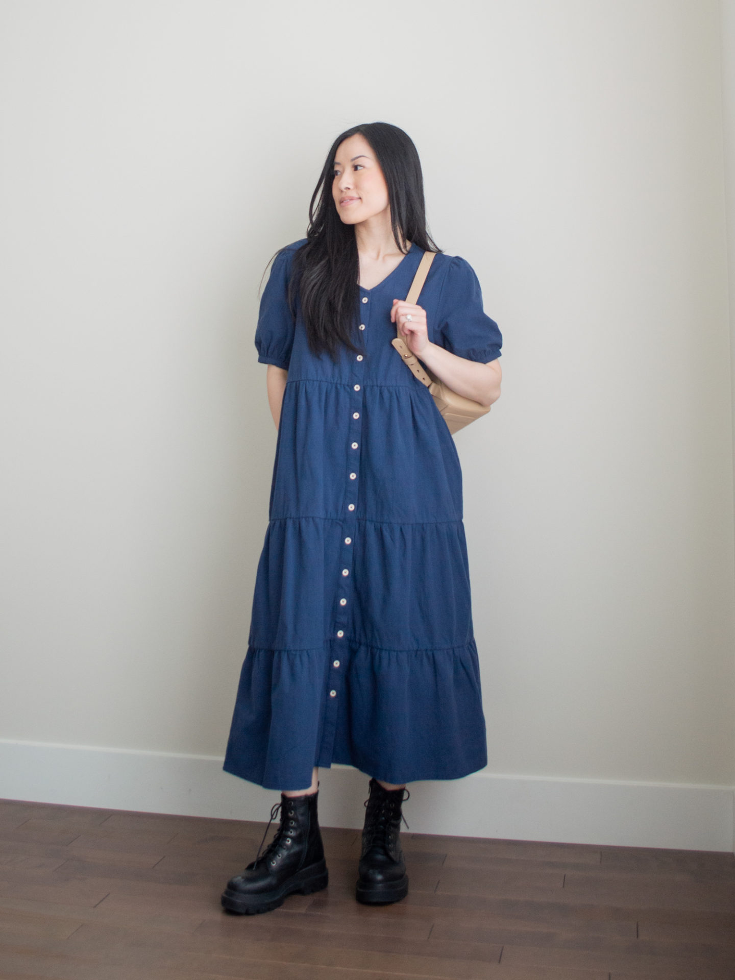 Sharon of Her Simple Sole showcases what to pack for vacation, including minimal and functional outfit ideas | tiered midi dress outfit | midi dress and combat boots outfit | sightseeing outfit | vacation packing list