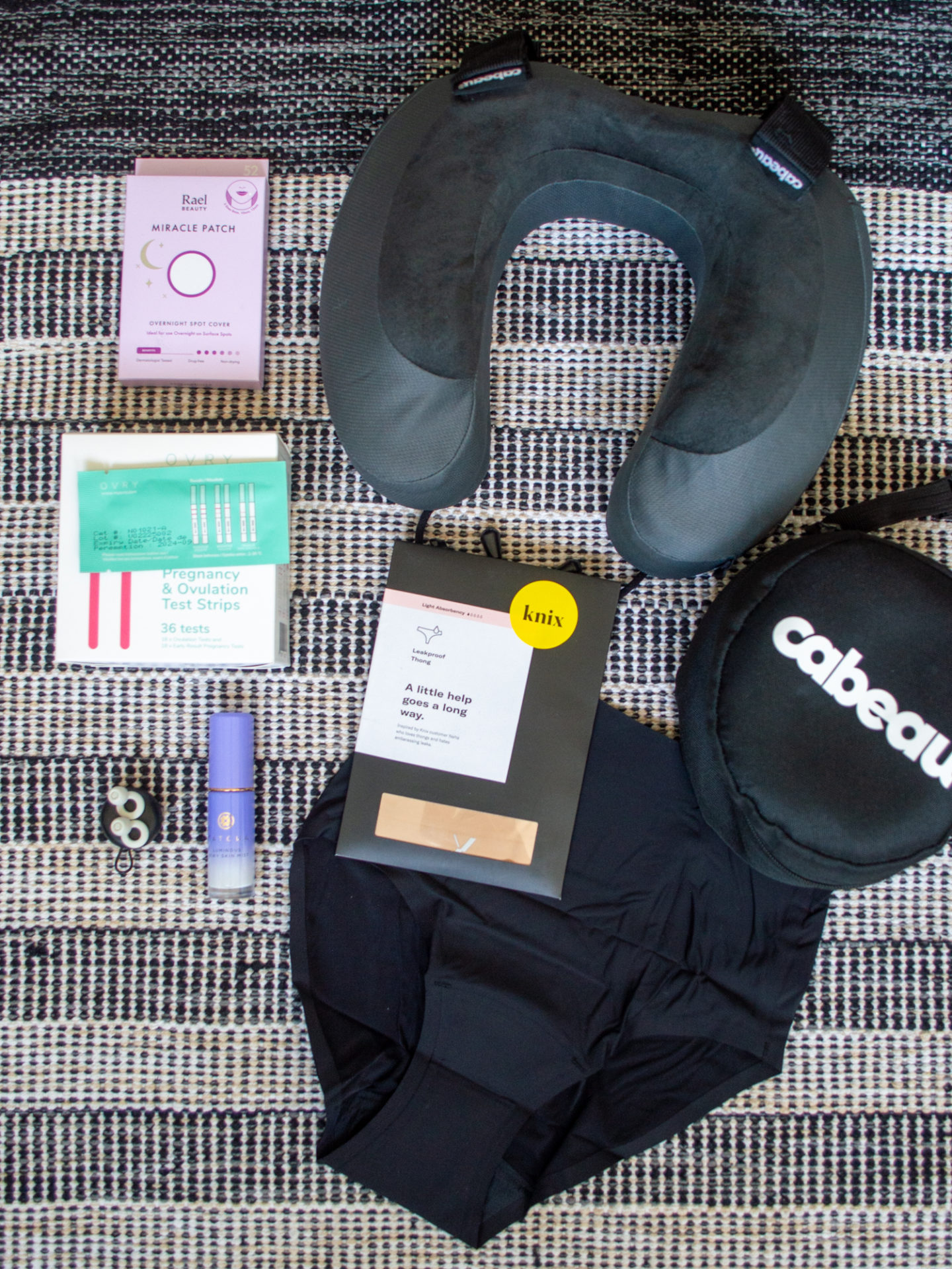 Sharon of Her Simple Sole showcases her ultimate travel essentials for a long haul flight and what to pack for vacation | travel products for personal needs | memory foam neck pillow | Knix absorbent underwear | pimple patches | ovulation stripes | facial spray | reusable ear plugs | travel packing list