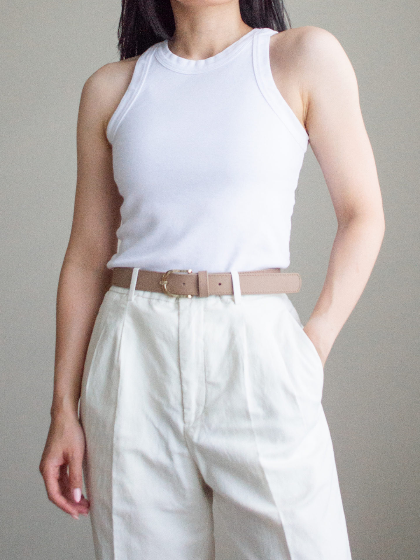 Close-up detailed outfit shot of Sharon of Her Simple Sole wearing a basic racerback tank top, linen pants, and a neutral belt | minimalist outfit ideas | tank top and pants outfit