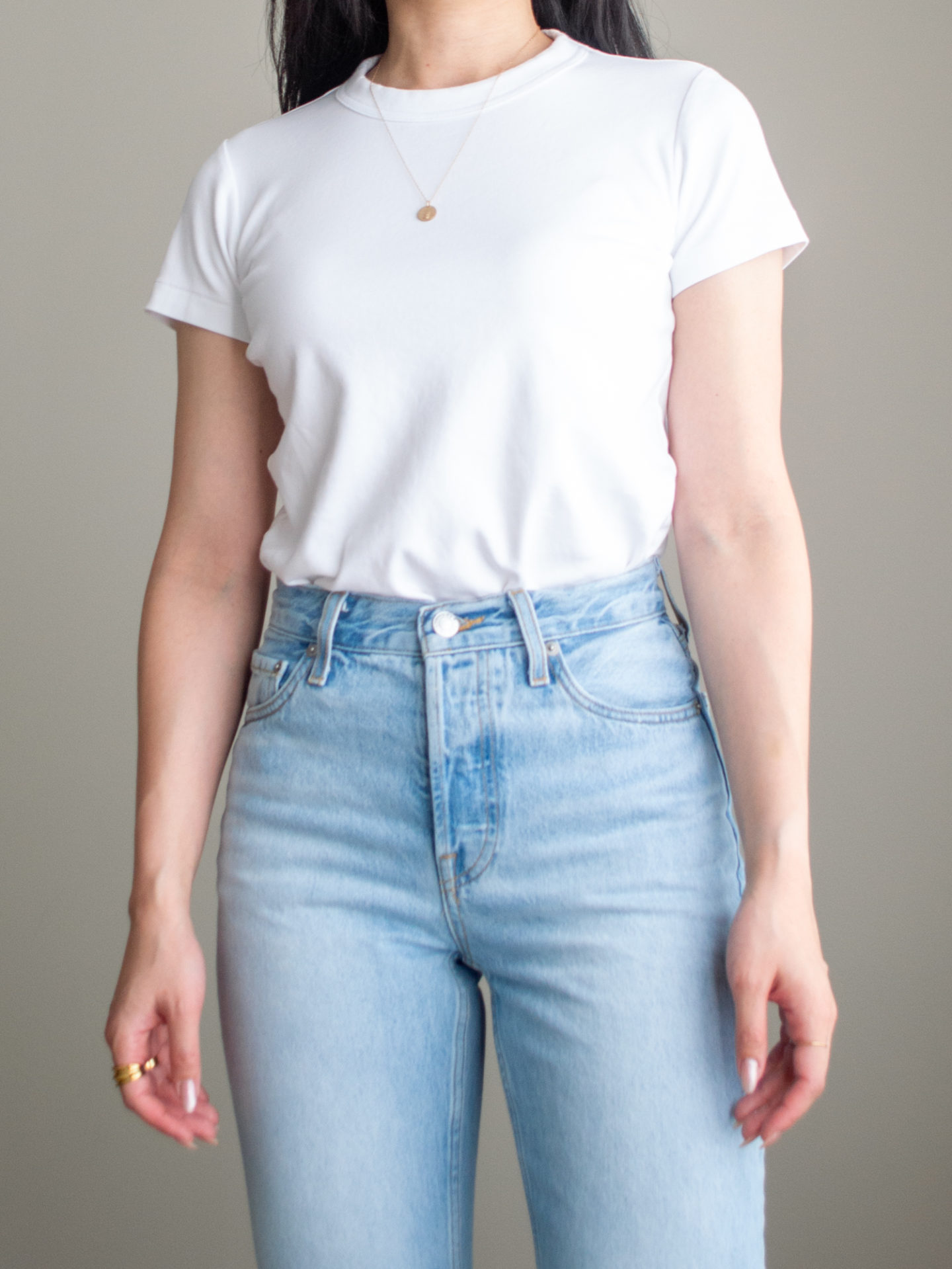 Close-up detailed outfit shot of Sharon of Her Simple Sole wearing a white basic t-shirt and blue straight leg jeans | minimalist outfit ideas | smart casual outfit