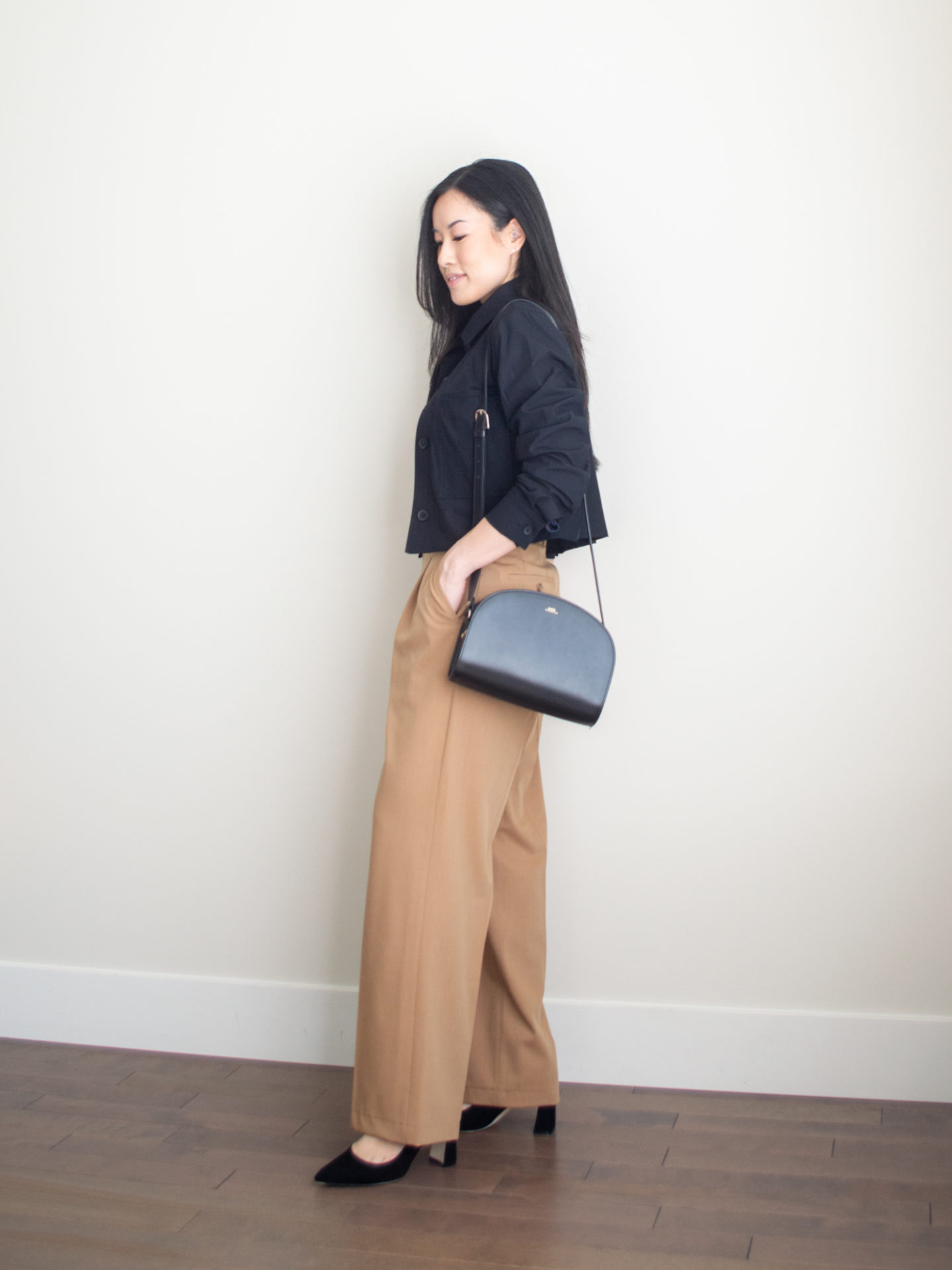 Sharon of Her Simple Sole is wearing a square neck tank top, a cropped jacket, brown wide leg pants, and bold block heels from Ally Shoes, while wearing a half moon black crossbody bag | minimalist outfit ideas | smart casual outfits | comfortable pumps