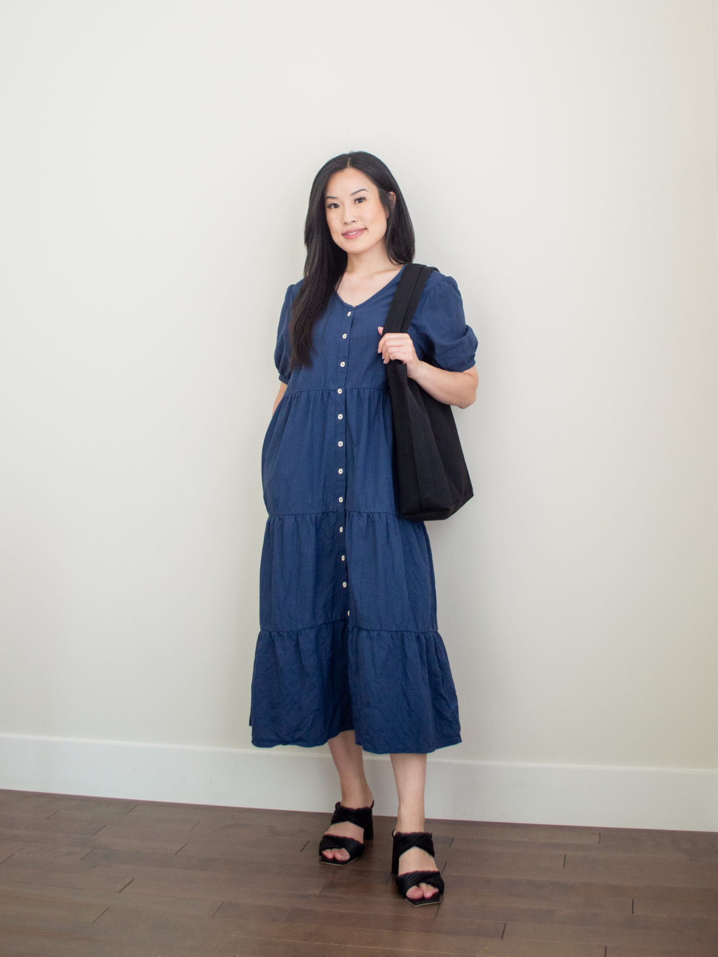 Sharon of Her Simple Sole is showcasing an outfits using simple pieces that make deciding what to pack easy, featuring a cotton midi dress, a black tote bag, and heeled sandals | minimalist outfits | simple outfit ideas