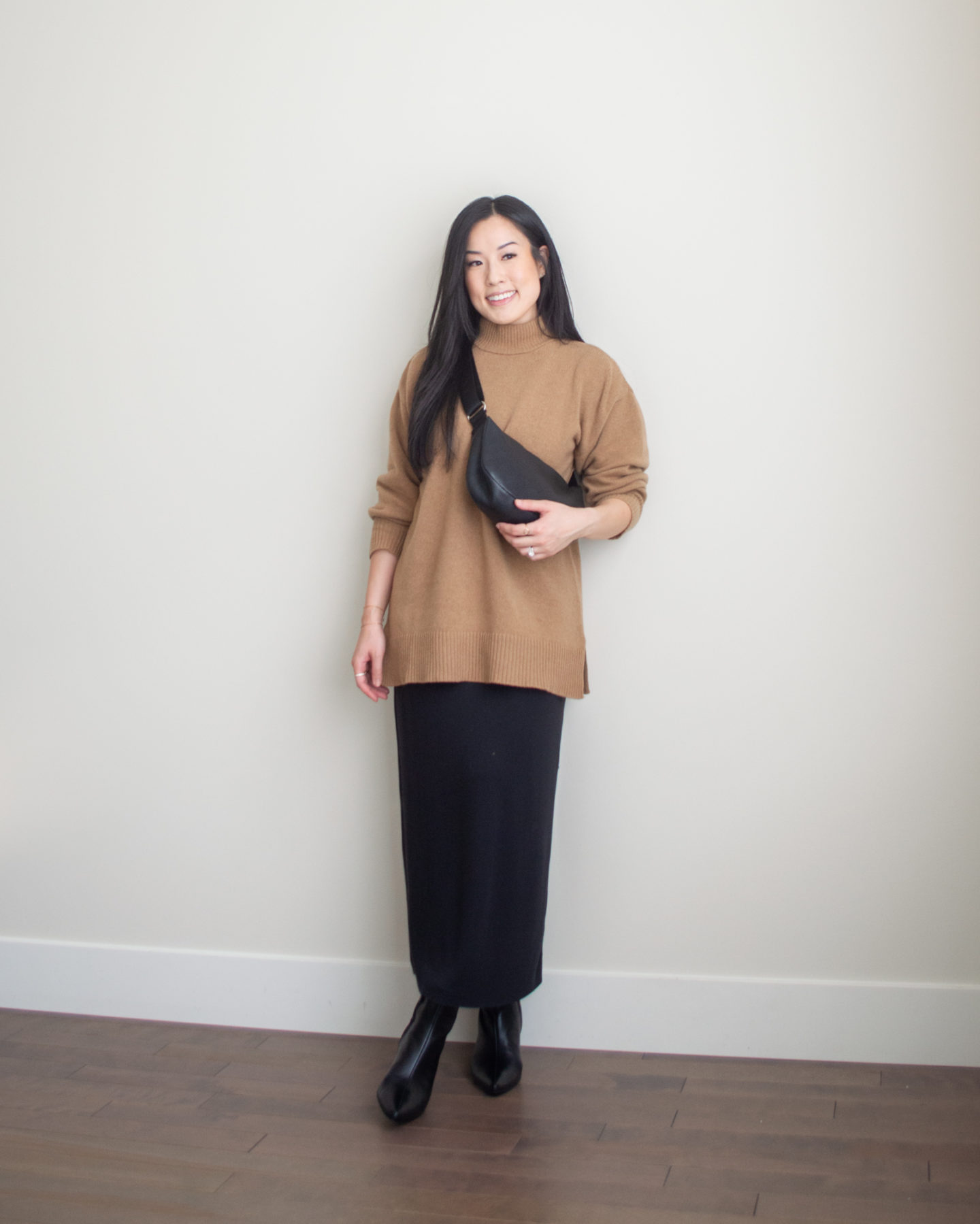 Sharon of Her Simple Sole is showcasing an outfit from her September outfit roundup, featuring a brown mockneck sweater, black maxi dress, a black slouchy bag and black pointy toe ankle boots | minimalist outfits | simple outfit ideas